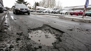 GERMANY, BONN, 02.02.2010, A rotten street with a lot of potholes in Germany.