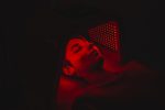 Osoba využíva red light terapiu na starostlivosť o pleť.