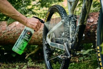 Čistenie pohonu bicykla pomocou čistiaceho prípravku a kefy na odstránenie nečistôt.